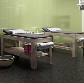 Medical tables on dark grey tile floor