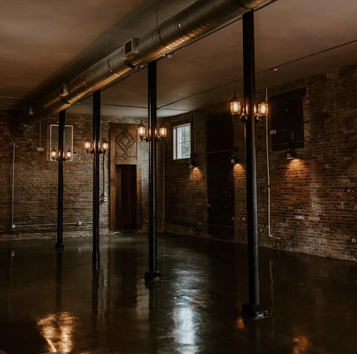 Large room with glossy concrete floors and lighting