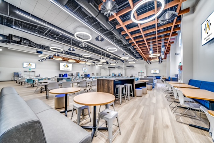 School common area with tables, chairs, work areas