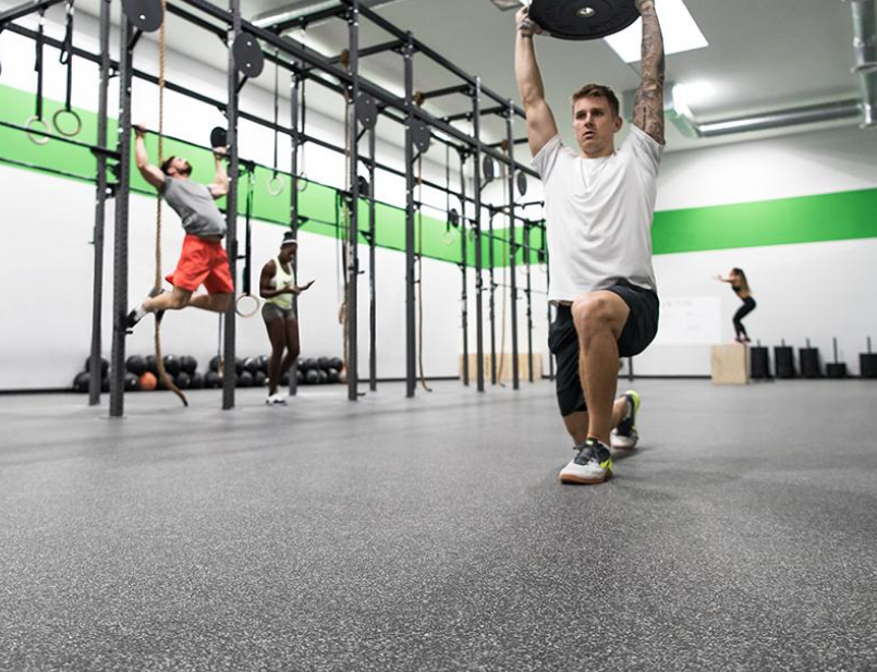 Man lifting a weight in a gym