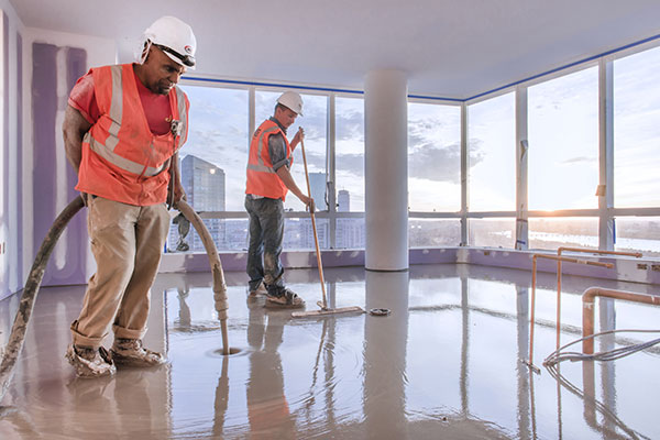 Installers pumping concrete